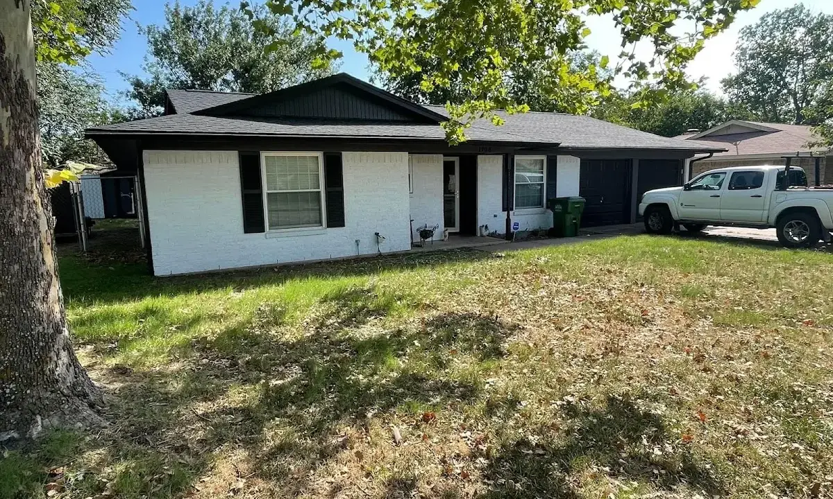 Professional roofing crew working on a residential roof in Malone